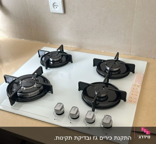 כיריים גז עם ארבעה מבערים וכפתורי שליטה